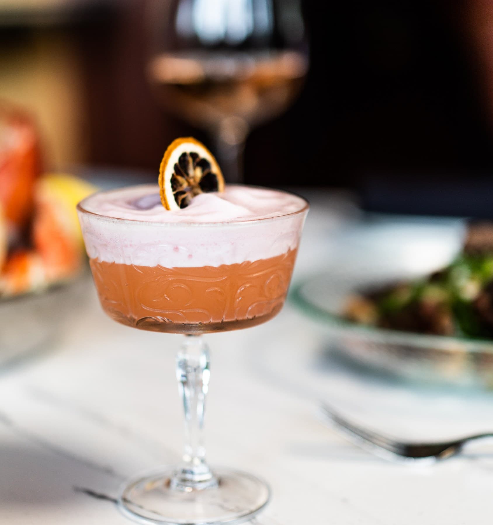 Signature cocktail in vintage coupe